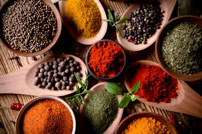 Assortment of spices in bowls and spoons